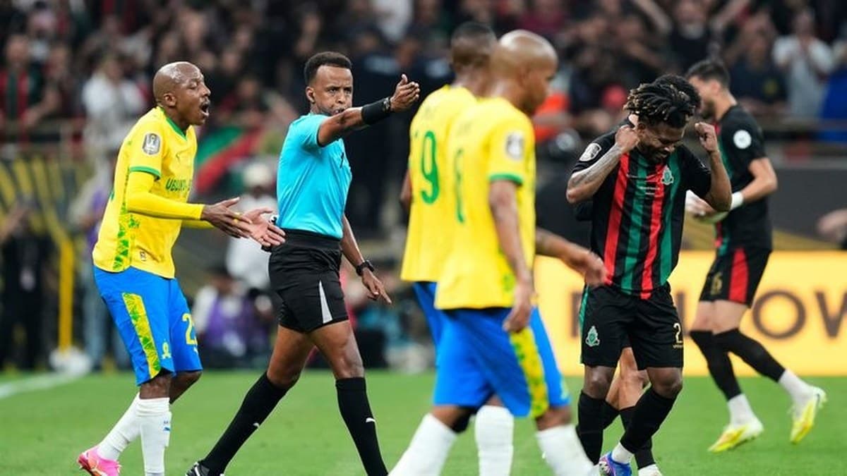 Omar Artan officiating an international football match
